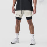 Tetra-Lite 7" Liner Short in Stone and Black, worn by model with white sneakers, front view
