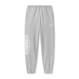 flatlay Tech-Terry Oversized Sweats joggers in heather grey with Global logo print, front view