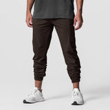 Dark brown Tetra-Lite Standard Zip Jogger worn with white sneakers, front view