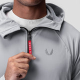 Training Hoodie in slate grey worn by model, front view with hand on zipper