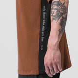 Supima Mesh Panel Oversized Tee in rust and black, worn by tattooed model showing side view