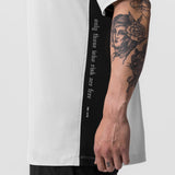 White Supima Mesh Panel Oversized Tee worn by tattooed model, side view
