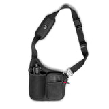 flatlay Water Bottle Holster Bag in black, front view with shoulder strap