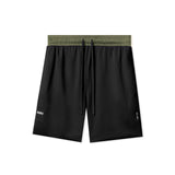 Flatlay of SilverPlus™ Mesh Reversible Shorts in black with olive waistband, laid flat from above