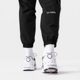 Black Ripstop Oversized Track Pant worn with white socks and sneakers, back view