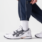 Navy ripstop oversized track pant worn with white socks and sneakers, side view
