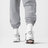 Ripstop Oversized Track Pant in slate grey worn with white socks and sneakers, back view