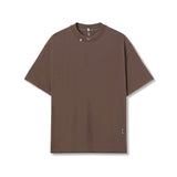 flatlay Tech Essential Relaxed Tee in faded dark earth, front view