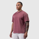 Tech Essential Relaxed Tee in faded crimson worn by male model, front view