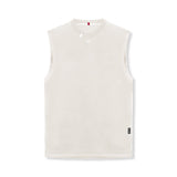 flatlay Tech Essential Relaxed Cutoff sleeveless tank in stone white, front view