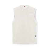 flatlay Tech Essential Relaxed Cutoff sleeveless tank in stone white, front view