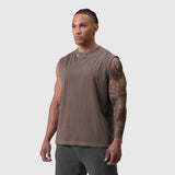 Tech Essential Relaxed Cutoff sleeveless tee in faded dark earth, worn by model