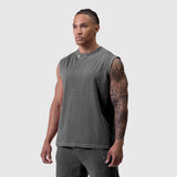 Tech Essential Relaxed Cutoff sleeveless tank in faded grey, worn by model