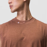 Tech Essential Relaxed Cutoff tee in faded rust, worn by model in profile view