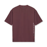 Flatlay of AeroSilver® Oversized Tee in plum with vertical text detail on right side
