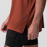 AeroSilver Oversized Tee in brick red worn with black shorts, side detail view