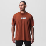 AeroSilver Oversized Tee in brick red with ASRV box logo, worn by model front view