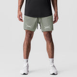 Tetra-Lite 7" Linerless Short in sage with bracket logo, front view on model