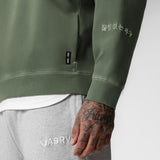Tech Essential Distressed Crewneck in faded olive worn by model, detail view of sleeve and chest