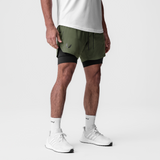 Tetra-Lite 7" Liner Short in olive and black worn with white socks and sneakers, side view