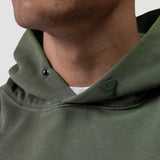 Tech Essential Distressed Hoodie in faded olive worn by model, detail view of neckline