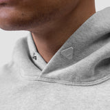Tech Essential Distressed Hoodie in Heather Grey, worn by model, chest detail
