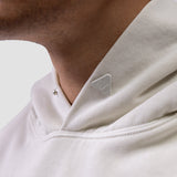 Tech Essential Distressed Hoodie in Faded Stone, worn by model showing shoulder and chest detail