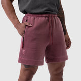 Tech Essential Sweat Short in faded crimson worn by model, side view