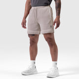Tech Essential Sweat Short in Faded Chai worn by model, front view