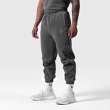 Tech Essential Sweats in faded grey worn by model, cropped jogger view with white socks and sneakers
