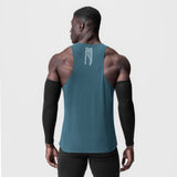 Laser-Vent™ Singlet Tank in storm blue, worn by model showing back view with arm sleeves