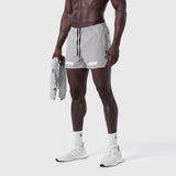 Aerotex 3" Distance Short in slate grey, worn by model holding matching jacket