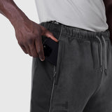 Black Tech-Terry mesh panel sweats worn by model with hand in pocket, side view