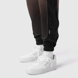 Tech-Terry Mesh Panel Sweats in black worn with white sneakers and white socks, lower body view