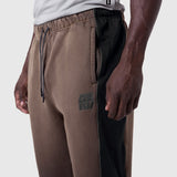 Tech-Terry Mesh Panel Sweats in dark earth with black side panels, worn by model, side view