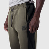 Tech-Terry Mesh Panel Sweats in olive with black mesh panels, side view on model