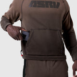 Tech-Terry Training Hoodie in dark earth, worn by model holding phone in front pocket