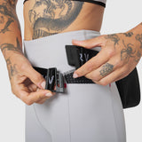 Trail Pack in Black, worn on model's waist, front view