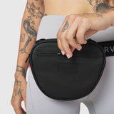Trail Pack in black, worn as crossbody bag on model