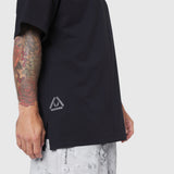 Black Supima Ice-Skin reversible tee on model, side view with tattooed arm visible