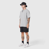 Supima Ice-Skin Reversible Tee in slate grey worn by model with black shorts, side view