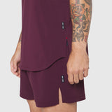 Aerotex Perforated Run Tank in merlot worn with matching shorts, side view