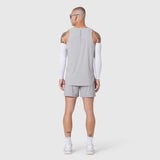 Aerotex Perforated Run Tank in slate grey worn by model, back view with white arm sleeves