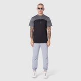 AEROSILVER® UPF50+ Run Tee in black and grey colorblock, worn by model with light grey joggers