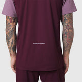 AEROSILVER® UPF50+ Run Tee in merlot, back view on model with visible 'Relentless Pursuit' text
