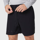 Black Revolutional Training Short worn by model, front view with drawstring detail