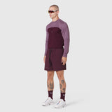 Revolutional Training Short in merlot, worn with matching long-sleeve top and socks, side view