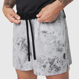 TETRA-LITE® 5" Linerless Training Short in Sedona Snow Camo, worn by model adjusting drawstring