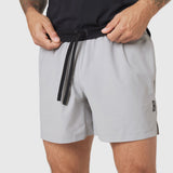 TETRA-LITE® 5" Linerless Training Short in Slate Grey, model wearing and adjusting drawstring