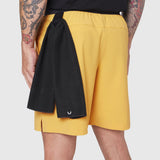 TETRA-LITE® 7" Linerless Training Short in amber, worn by model from behind with black towel